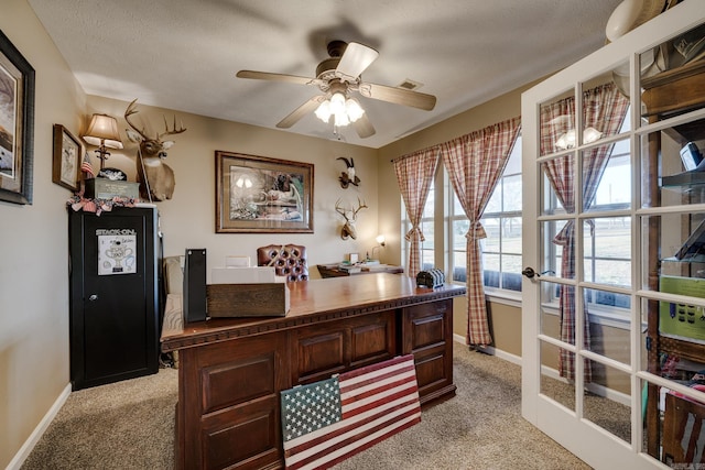 home office with light carpet, ceiling fan, french doors, and a textured ceiling