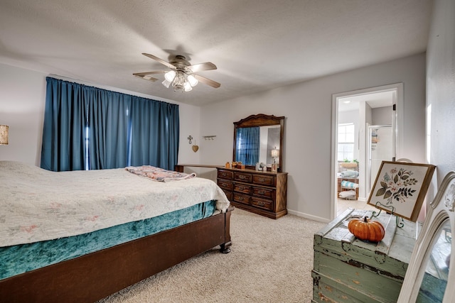 bedroom with ceiling fan, a textured ceiling, and carpet flooring