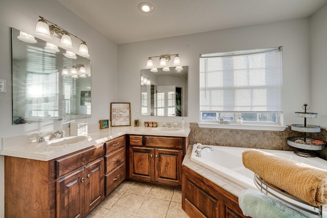 bathroom featuring a tub, tile patterned floors, plenty of natural light, and vanity