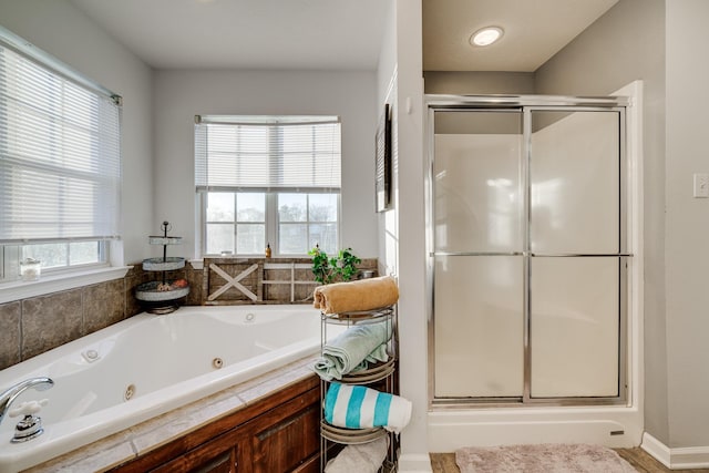 bathroom with independent shower and bath and plenty of natural light