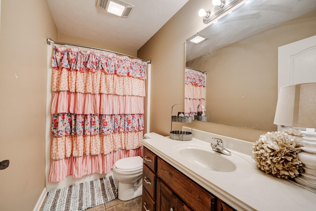 bathroom with toilet, tile patterned floors, a textured ceiling, vanity, and curtained shower