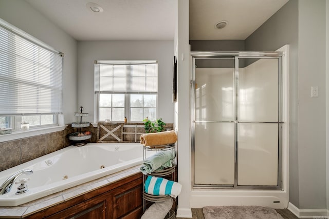 bathroom featuring plenty of natural light and independent shower and bath