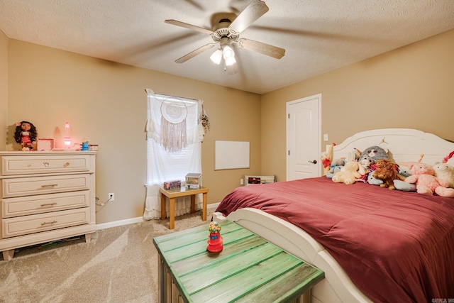 bedroom with light carpet, ceiling fan, and a textured ceiling