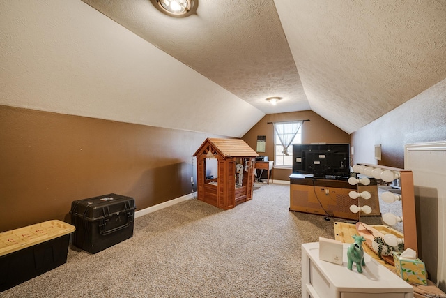 carpeted home office with a textured ceiling and lofted ceiling