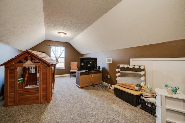 additional living space featuring lofted ceiling, carpet, and a textured ceiling