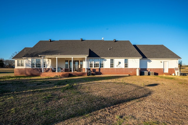 back of house with a lawn and a porch