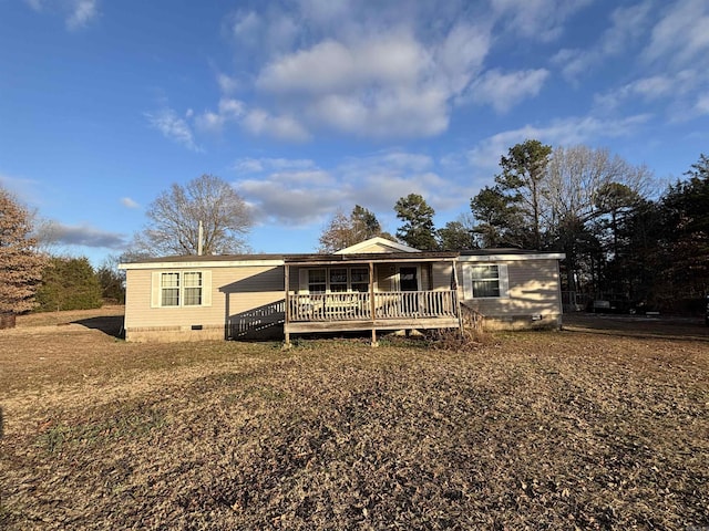 rear view of property featuring a wooden deck