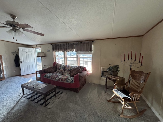 carpeted living room with ceiling fan, a textured ceiling, heating unit, and ornamental molding