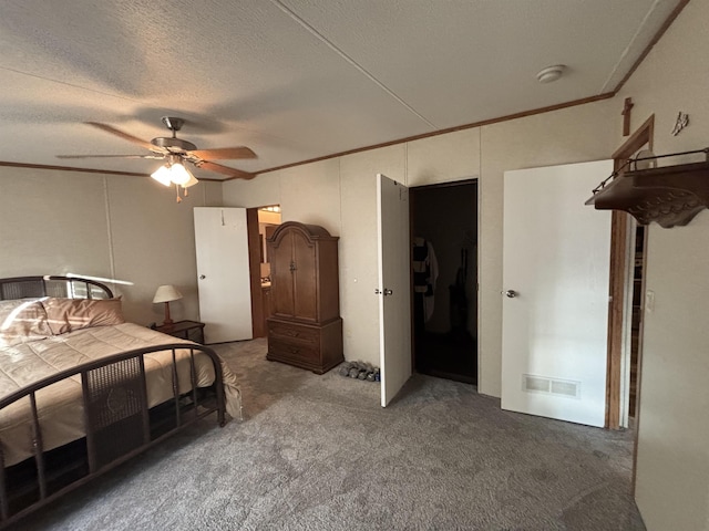 bedroom featuring a textured ceiling, ceiling fan, carpet flooring, and crown molding