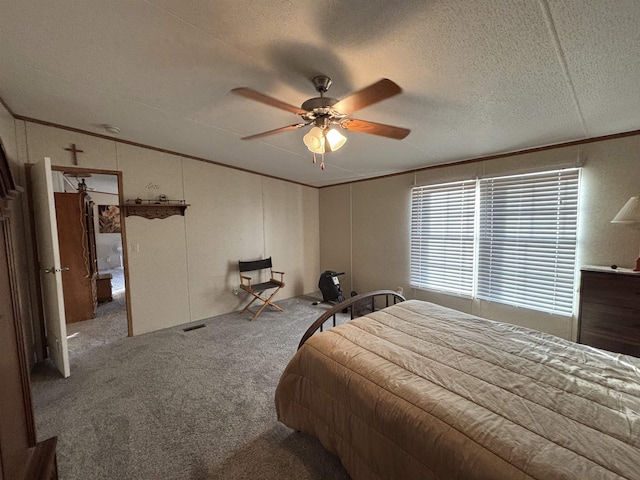 bedroom featuring a textured ceiling, ceiling fan, crown molding, and carpet floors