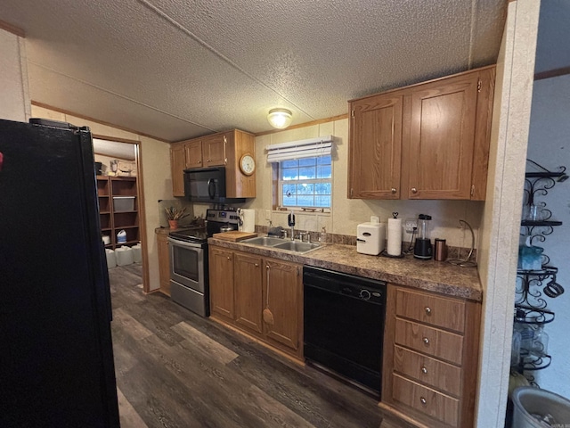 kitchen featuring vaulted ceiling, black appliances, sink, dark wood-type flooring, and a textured ceiling