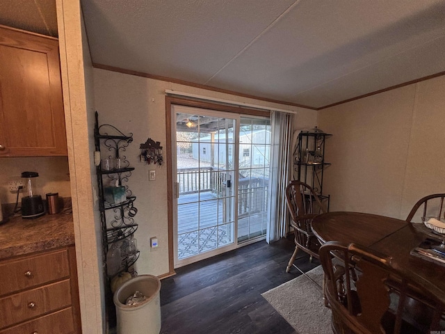 dining space with dark hardwood / wood-style floors and ornamental molding