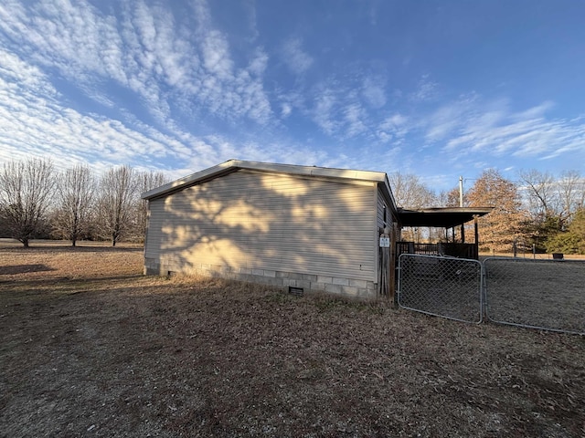 view of side of property with a carport