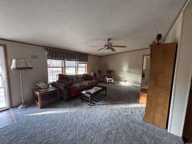 carpeted living room featuring a textured ceiling, ceiling fan, and crown molding