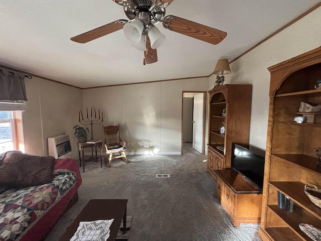 carpeted living room featuring heating unit, ceiling fan, and ornamental molding