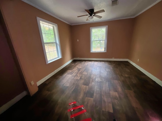 unfurnished room featuring ceiling fan, dark hardwood / wood-style floors, and ornamental molding