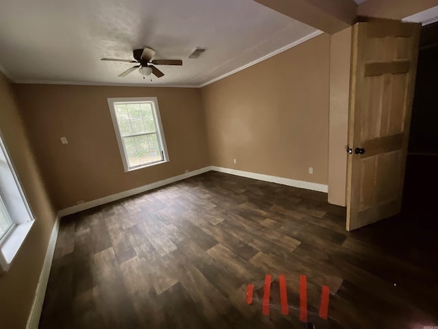 empty room with ceiling fan, dark wood-type flooring, and ornamental molding