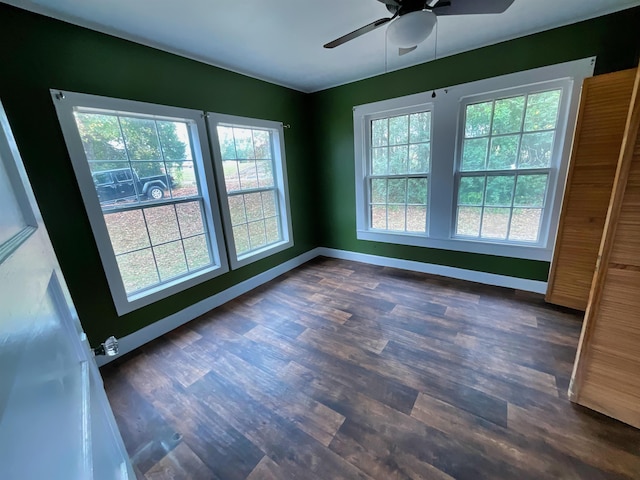 unfurnished room with ceiling fan and dark wood-type flooring