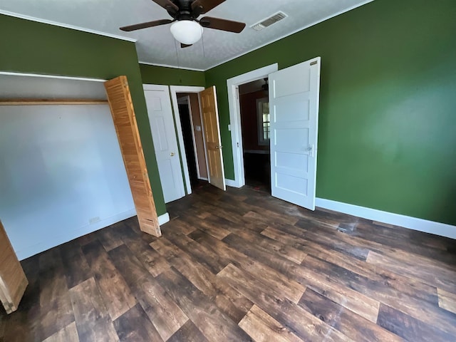 unfurnished bedroom with ceiling fan and dark wood-type flooring