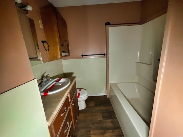 bathroom with toilet, vanity, and hardwood / wood-style flooring