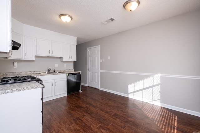 kitchen featuring black dishwasher, dark hardwood / wood-style flooring, a textured ceiling, white cabinets, and sink