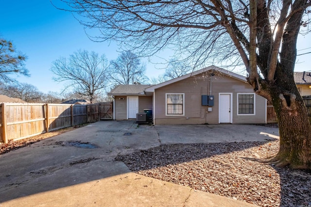 rear view of property with central AC and a patio