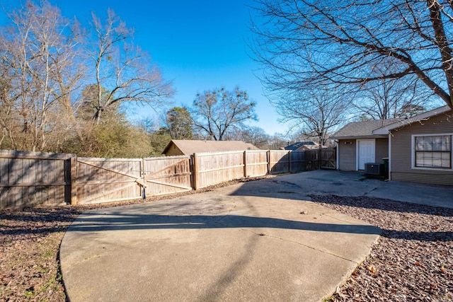 view of yard with central AC and a patio