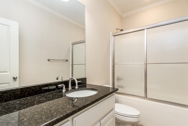 full bathroom featuring toilet, combined bath / shower with glass door, crown molding, and vanity