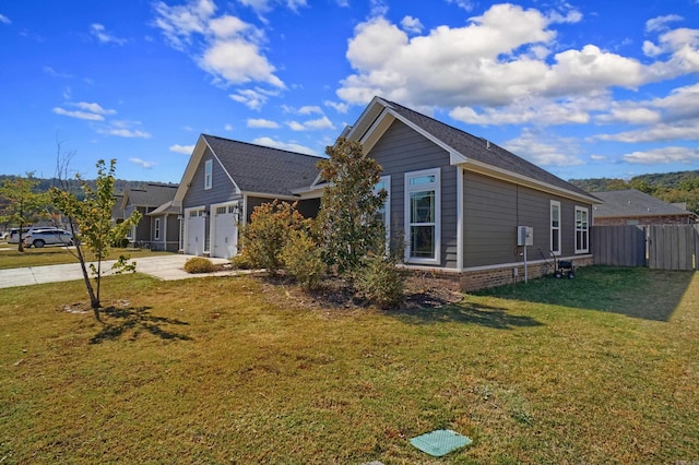 view of front of house featuring a front yard and a garage