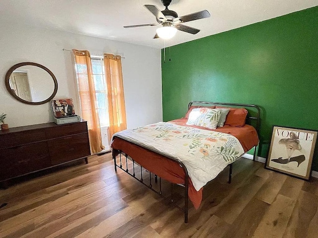 bedroom featuring ceiling fan and hardwood / wood-style flooring