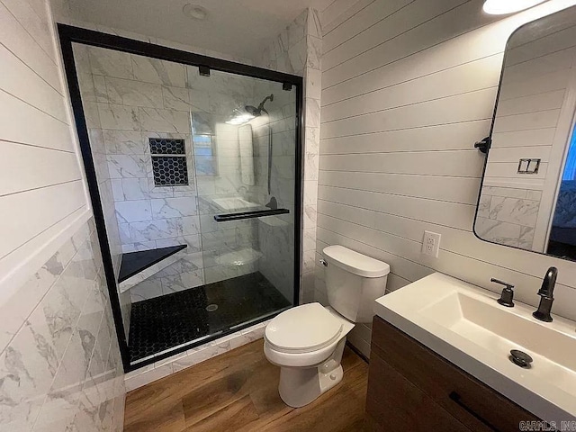 bathroom featuring hardwood / wood-style floors, an enclosed shower, vanity, toilet, and wood walls