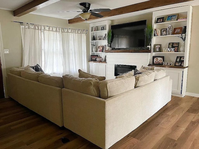 living room with ceiling fan, crown molding, dark hardwood / wood-style floors, and beam ceiling