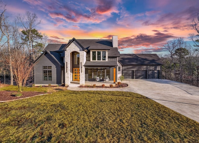 view of front of house featuring a garage and a yard