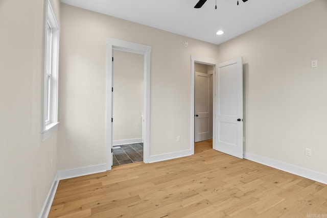 unfurnished bedroom featuring ceiling fan and light wood-type flooring