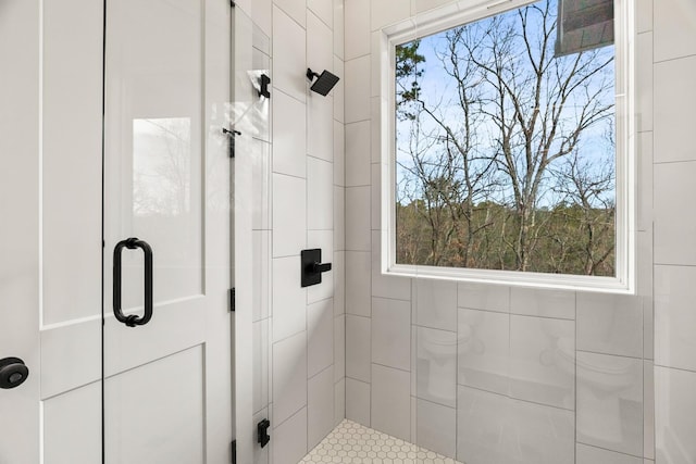 bathroom with a shower with door