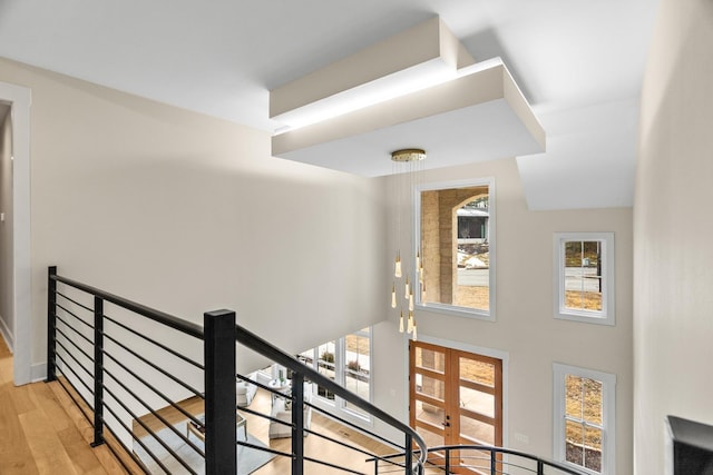 staircase featuring french doors and hardwood / wood-style floors