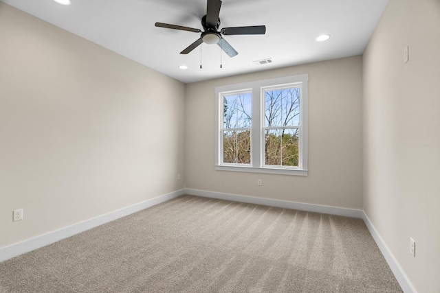 spare room featuring ceiling fan and carpet