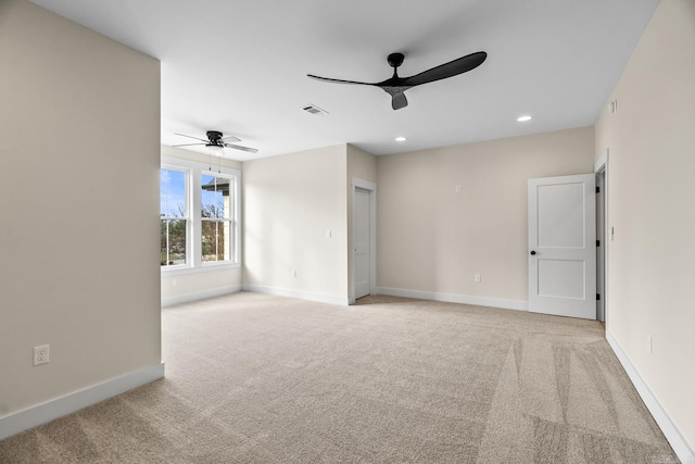 carpeted empty room featuring ceiling fan