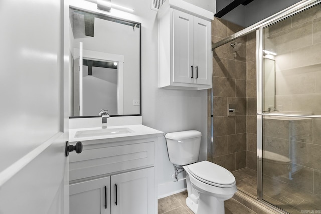 bathroom with tile patterned flooring, toilet, a shower with door, and vanity