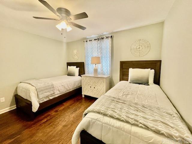 bedroom featuring ceiling fan and dark hardwood / wood-style flooring