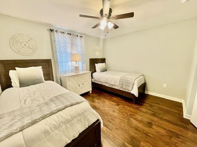 bedroom featuring ceiling fan and dark wood-type flooring