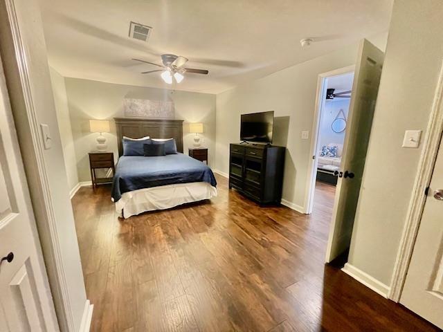 bedroom with ceiling fan and dark wood-type flooring