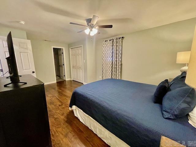 bedroom with ceiling fan and dark wood-type flooring