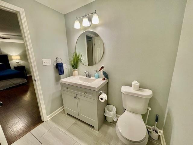 bathroom featuring toilet, tile patterned flooring, and vanity