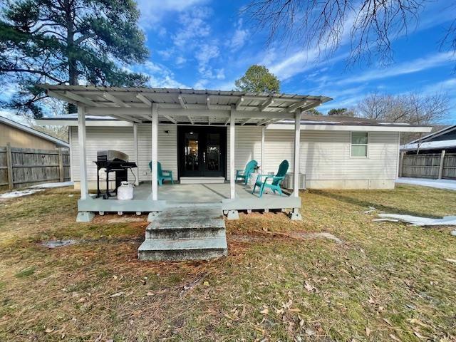 back of house featuring a pergola, a wooden deck, and a yard