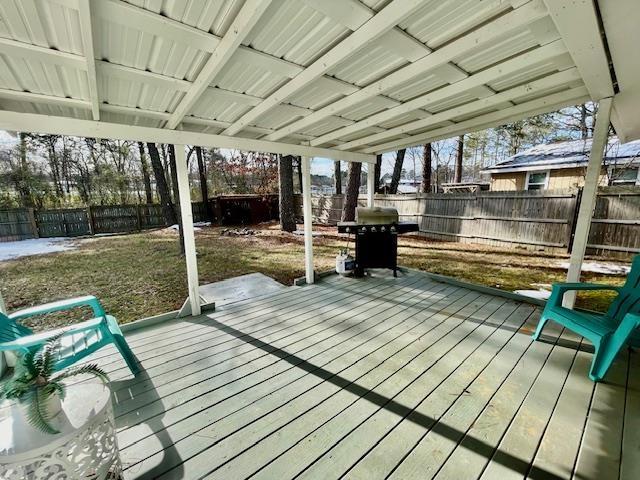 deck with a lawn and a grill