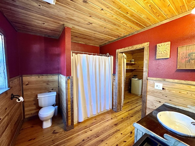 bathroom featuring toilet, wood ceiling, hardwood / wood-style floors, walk in shower, and vanity