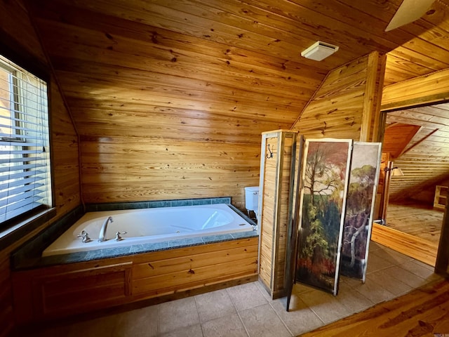 bathroom with vaulted ceiling, wood ceiling, wooden walls, and a washtub