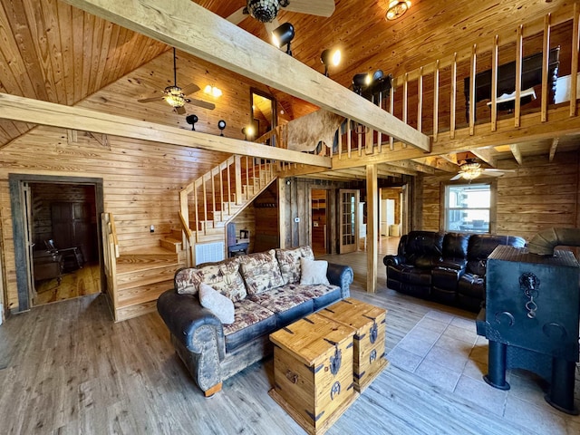 living room with wood walls, hardwood / wood-style floors, beam ceiling, wood ceiling, and high vaulted ceiling