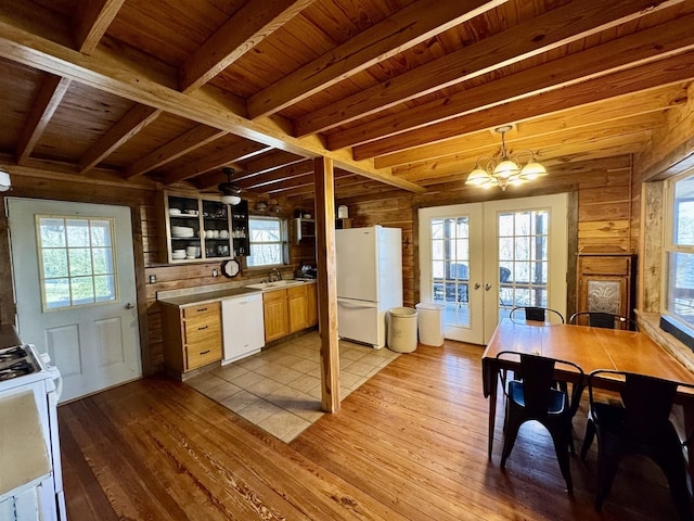 kitchen featuring decorative light fixtures, wood walls, beamed ceiling, white appliances, and wooden ceiling